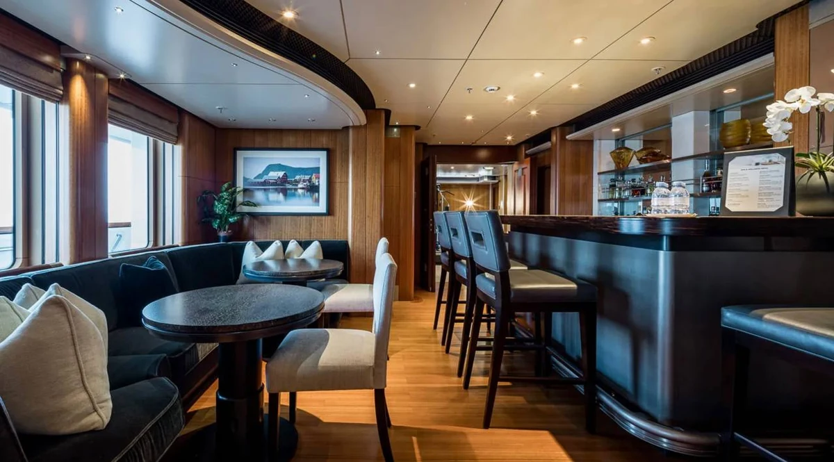 Octopus wood-panelled bar with counter seating and round tables beside the windows