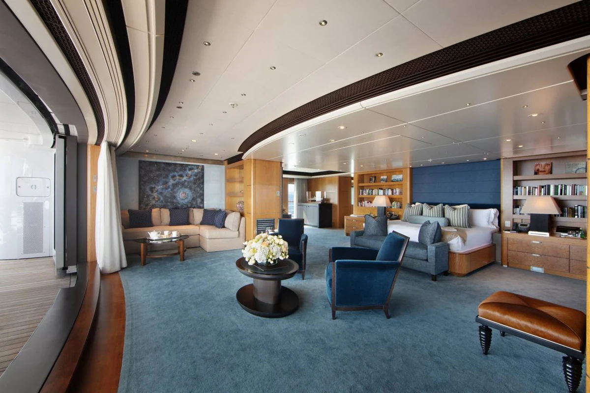 Octopus bedroom suite with blue seating, bookshelves and a sea-facing terrace